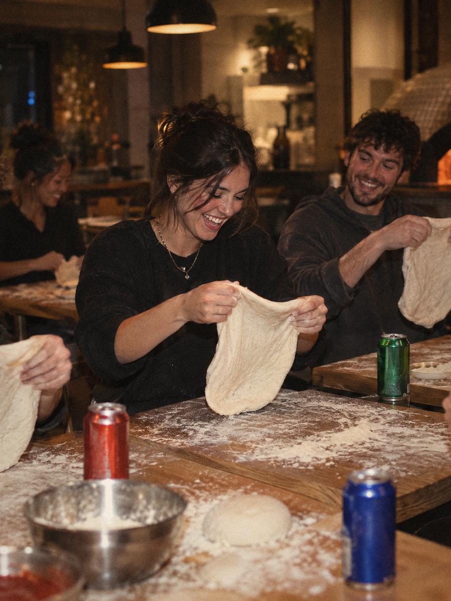 Friends at the tables stretching their own practice dough